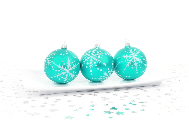 three christmas ornaments sitting on top of a white plate, a photo, white cyan, professional product photo, with stars, high resolution product photo