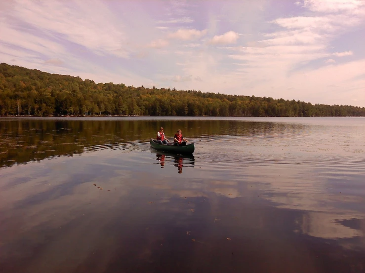 a couple of people in a small boat on a lake, by Susan Heidi, flickr, extremely wide angle shot, cornell, camp, very reflective