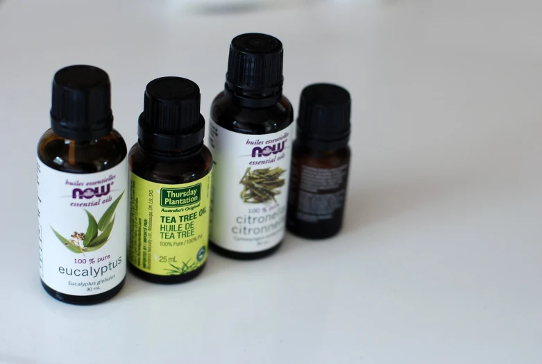 three bottles of essential oils sitting on a table, by Elizabeth Durack, antipodeans, panorama, taken with a canon dslr camera, green tea, high res photo