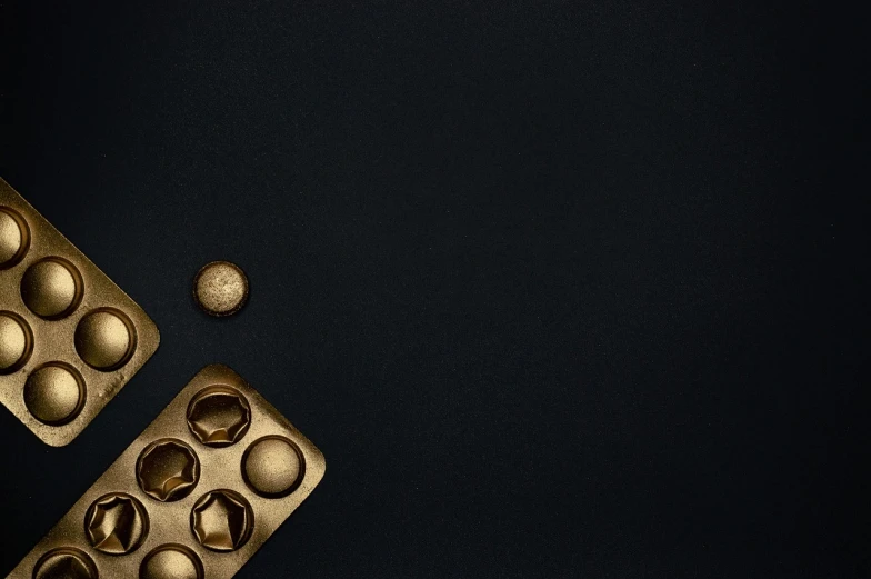 a couple of muffins sitting on top of a table, digital art, inspired by Hedi Xandt, unsplash, minimalism, metallic buttons, brass sheet, dark palette, abstract claymation