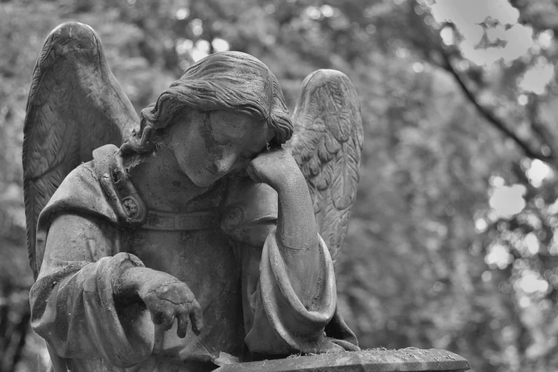 a black and white photo of a statue of an angel, pixabay contest winner, looks sad and solemn, mourning family, closeup photo, beautiful surroundings