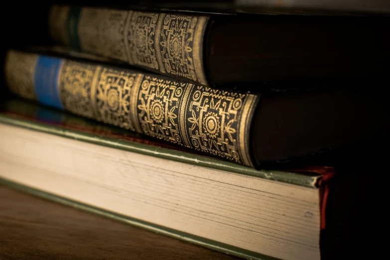 a stack of books sitting on top of each other, a macro photograph, renaissance, fine detail post processing, cinematic closeup, 17th-century, ornately detailed