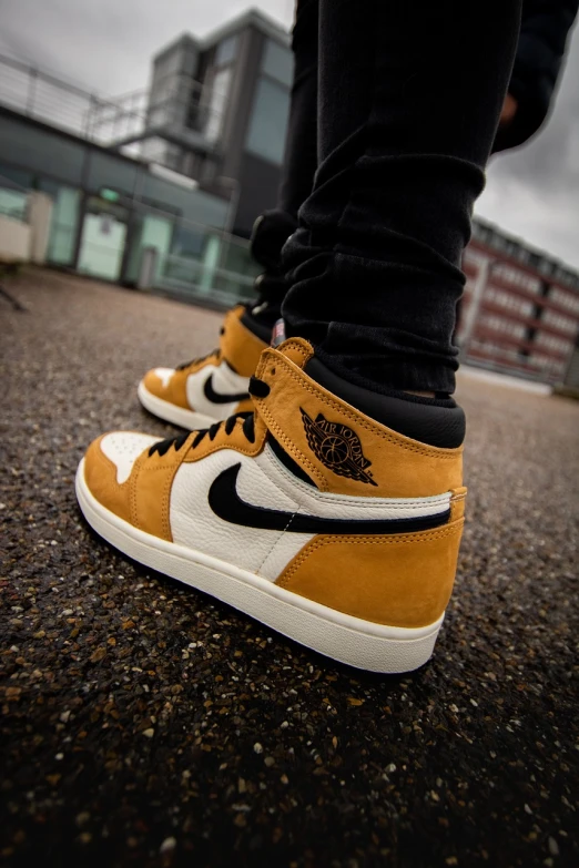 a close up of a person's shoes on the ground, inspired by Jordan Grimmer, air jordan 1 high, ocher details, standing on rooftop, two tone