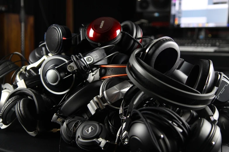 a pile of headphones sitting on top of a desk, reddit, bauhaus, dof wide, mega-detailed, rack, various posed