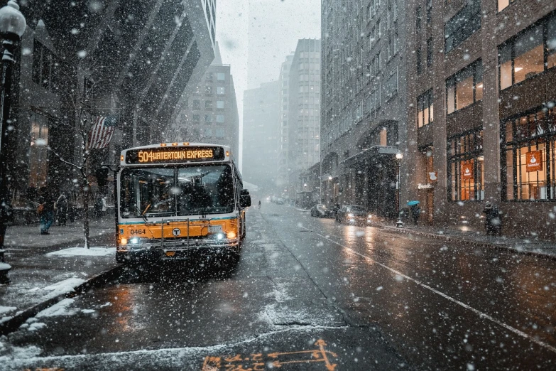 a bus driving down a snowy street next to tall buildings, by Andrew Domachowski, unsplash contest winner, snowstorm ::5, cold as ice! 🧊, closeup portrait shot, public bus