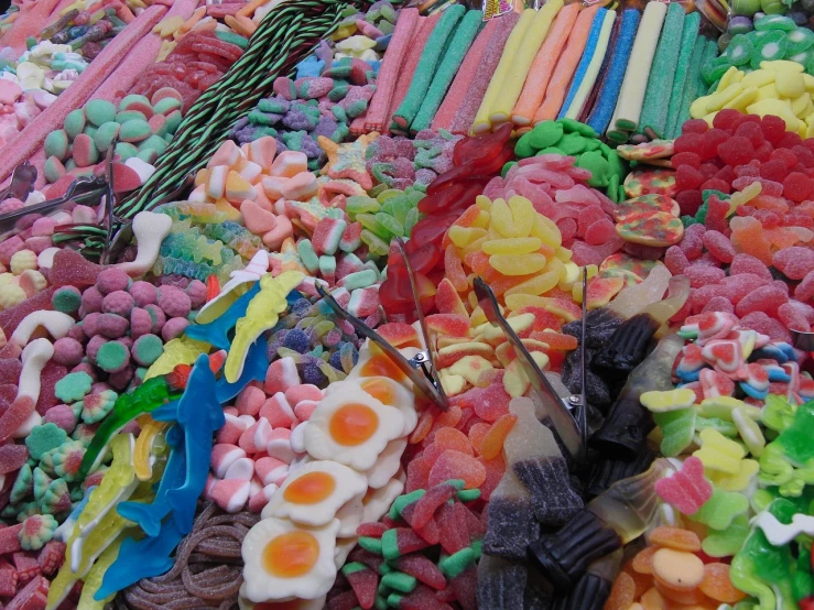 a large pile of candy sitting on top of a table, a picture, by Lee Loughridge, full of colour 8-w 1024, award winning ”, jackstraws, about to consume you