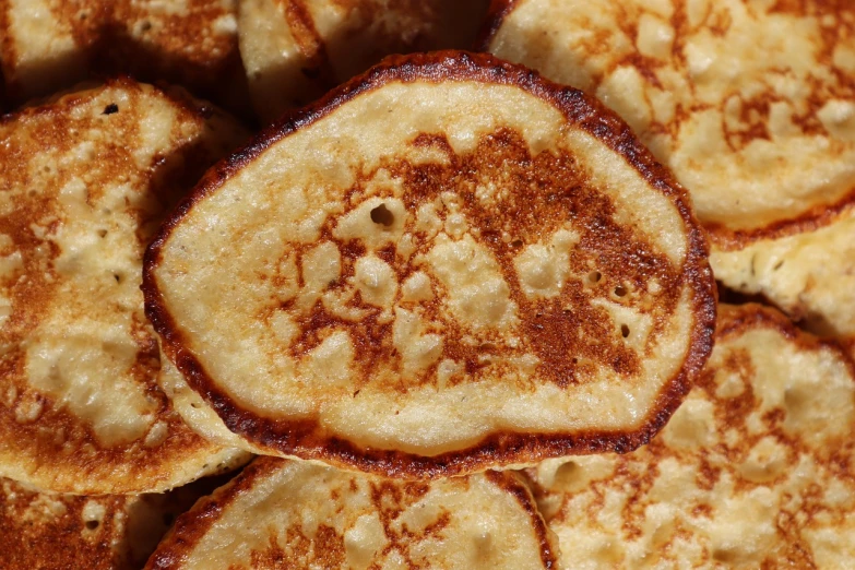 a pile of pancakes sitting on top of each other, a stipple, by Dietmar Damerau, pexels, high angle close up shot, deep fried, orthodox, detailed zoom photo