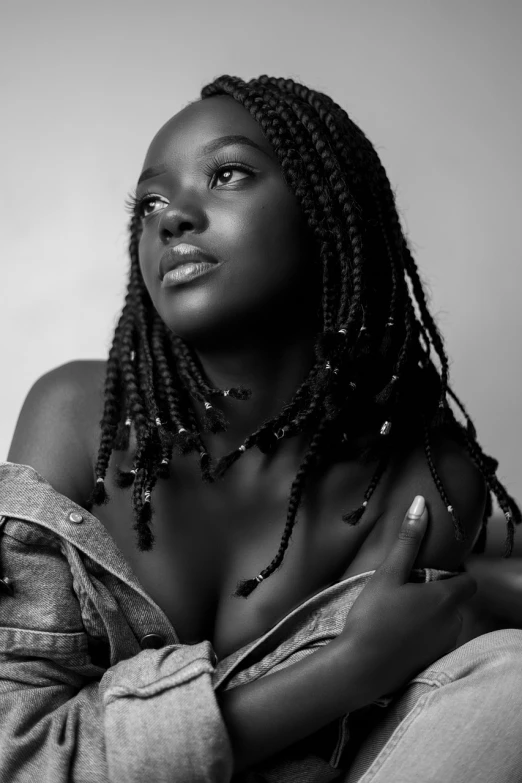 a black and white photo of a woman with dreadlocks, a black and white photo, inspired by Chinwe Chukwuogo-Roy, trending on cg society, portrait sophie mudd, dark skin tone, with a cool pose, captured on canon eos r 6