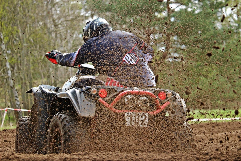 a man riding an atv in the mud, a picture, by Edward Corbett, shutterstock, sand particles, avatar image, outdoor photo, profile picture