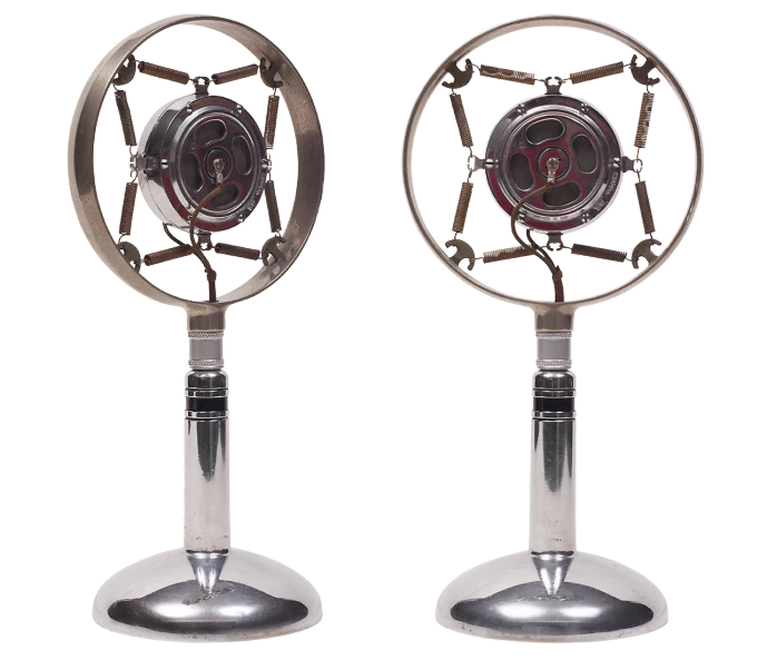 a couple of metal fans sitting on top of each other, concept art, by Lajos Vajda, art nouveau, studio microphone, front and side views, in style of chrome hearts, rotary symmetrical