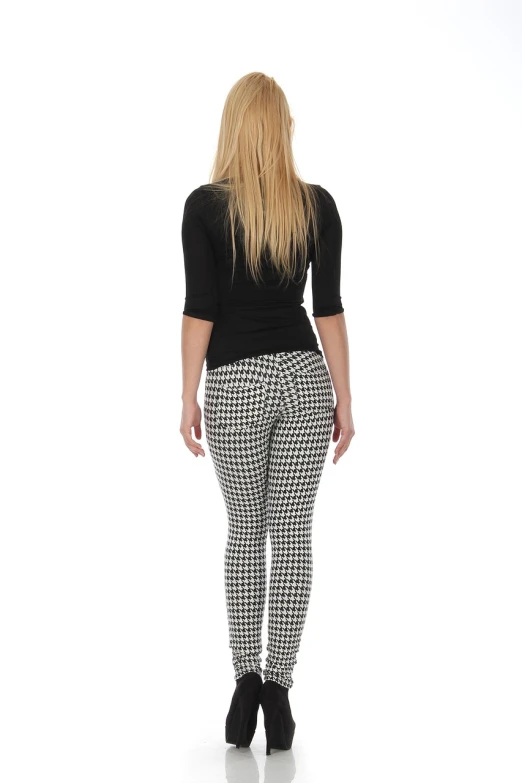 a woman in a black top and houndsered pants, a picture, trending on pixabay, op art, isolated white background, skinny female artist back view, checkered pattern, full body photo