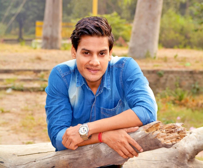 a man in a denim shirt leaning on a log, a portrait, inspired by Rajesh Soni, cute young man, portait photo profile picture, television show, high res