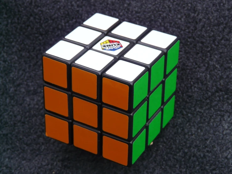 a rubik cube sitting on top of a black surface, inspired by Ernő Rubik, 3 colour, akiri toriyama, panzer, shenzhen