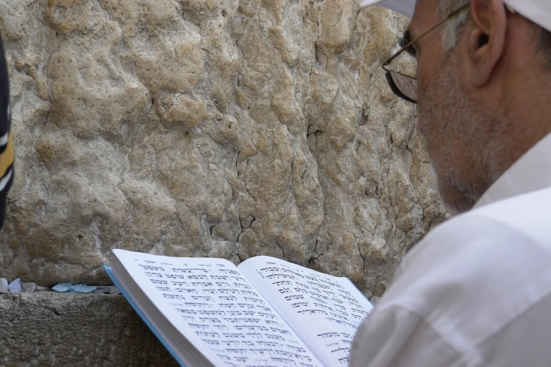 a man reading a book at the wai wai wai wai wai wai wai wai wai wai wai wai wai wai wai wai wai wai wai wai wai, a picture, by Siona Shimshi, les nabis, the western wall, holy ceremony, afp, textured