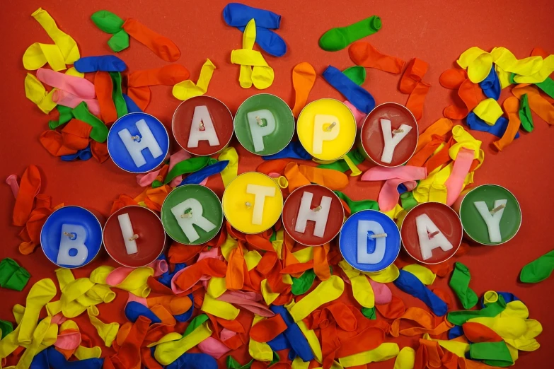 a bunch of balloons that say happy birthday, a picture, by Dietmar Damerau, shutterstock, colorful torn fabric, stock footage, sprinkles, red green yellow color scheme