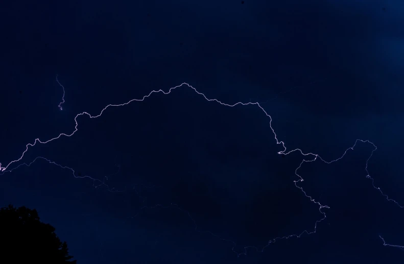 a sky filled with lots of lightning next to trees, by Jan Rustem, flickr, hurufiyya, mariana trench, zoomed out view, outline glow, laos