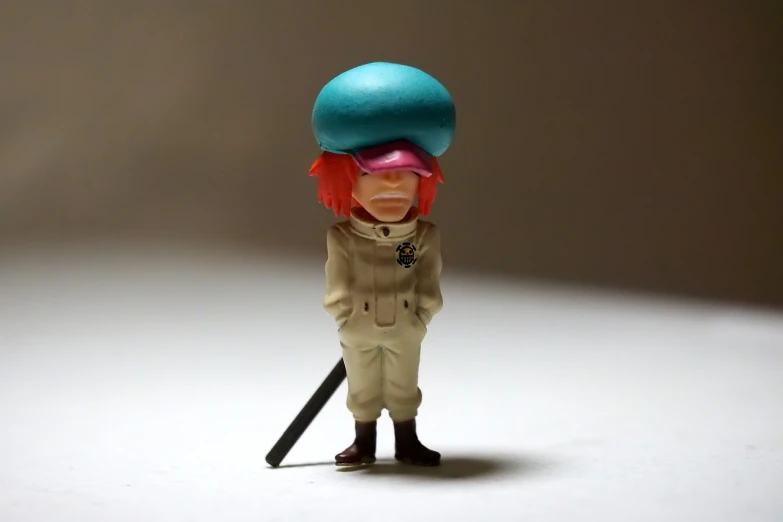 a close up of a figurine of a person with a hat on, inspired by Jamie Hewlett, neo-dada, kakyoin, female explorer mini cute girl, wearing a general\'s uniform, toy photo