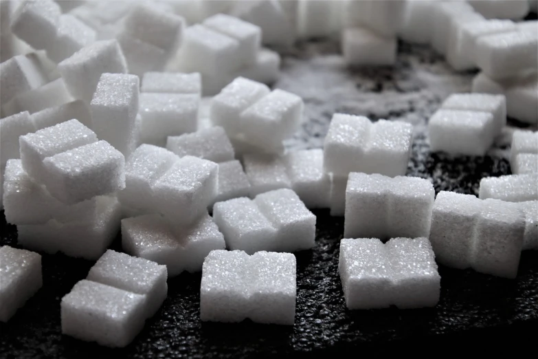 a pile of sugar cubes sitting on top of a table, by Hiroyuki Tajima, figuration libre, about to consume you, sugar snow, white on black, a table full of candy