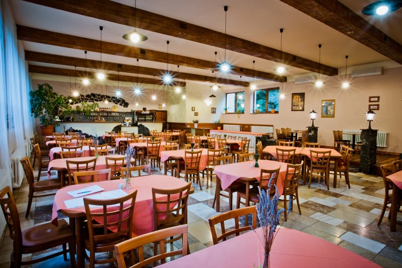 a dining room filled with lots of tables and chairs, by Aleksander Gierymski, shutterstock, with soft pink colors, olive garden, romanian, tx