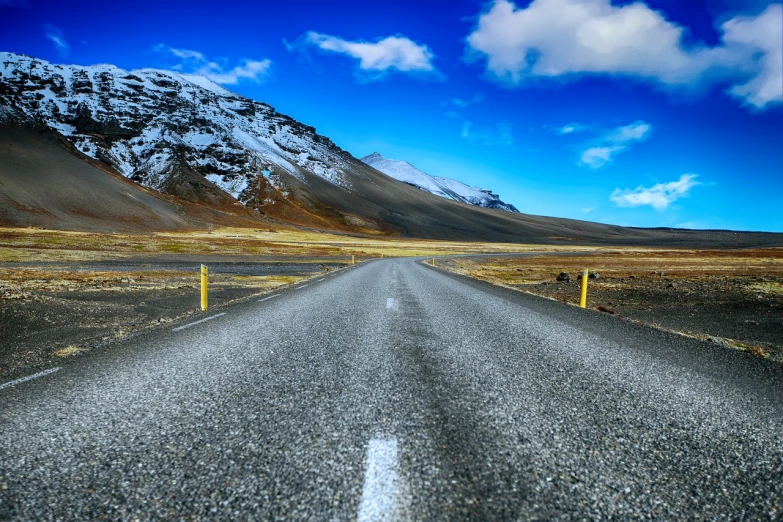 an empty road with mountains in the background, a tilt shift photo, by Hallsteinn Sigurðsson, shutterstock, vertical wallpaper, icy road on a planet of lava, hdr photo, very accurate photo