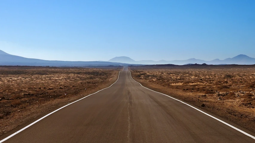 an empty road in the middle of the desert, a picture, by Andrei Kolkoutine, flickr, volcanic landscape, horizon forbideen west, clean long lines, traffic