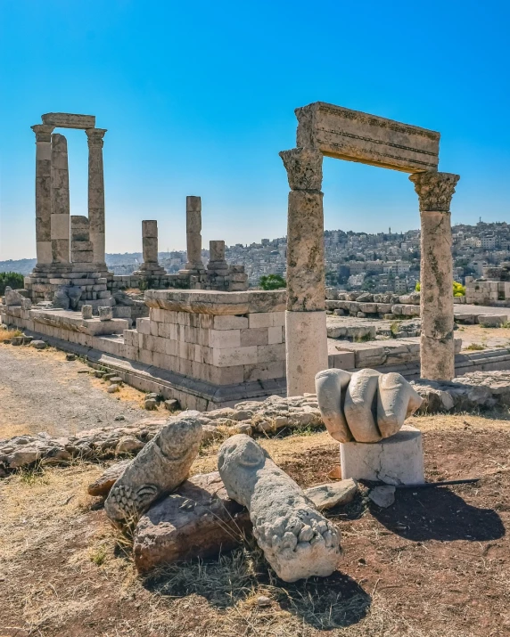 a stone bench sitting on top of a dirt field, a marble sculpture, shutterstock, ancient greek temple ruins, background is a city in ruins, two horns, jordan