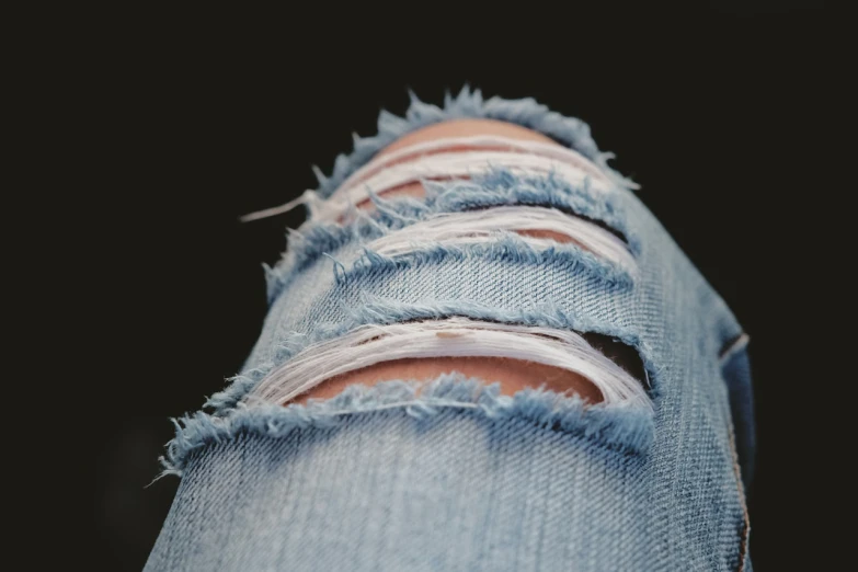 a close up of a person's ripped jeans, by Nándor Katona, pexels, knee, naturalistic technique, stock photo, detailed realistic