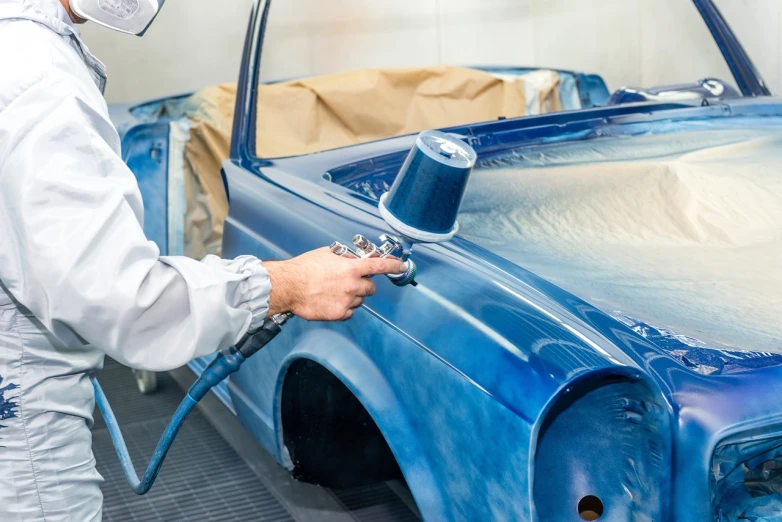 a man is painting a blue car with a spray gun, an airbrush painting, shutterstock, vintage - w 1 0 2 4, ditigal painting, restoration, oild painting