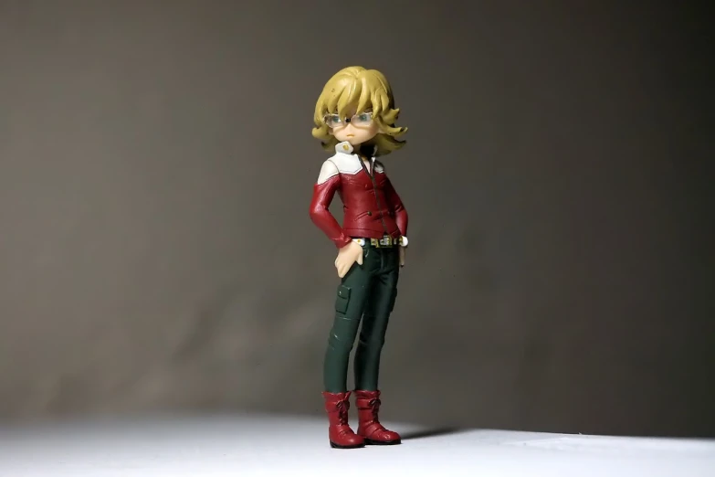a close up of a figurine of a person, a picture, tumblr, shin hanga, red shirt brown pants, curly blonde hair | d & d, !!full body portrait!!, kamen rider character