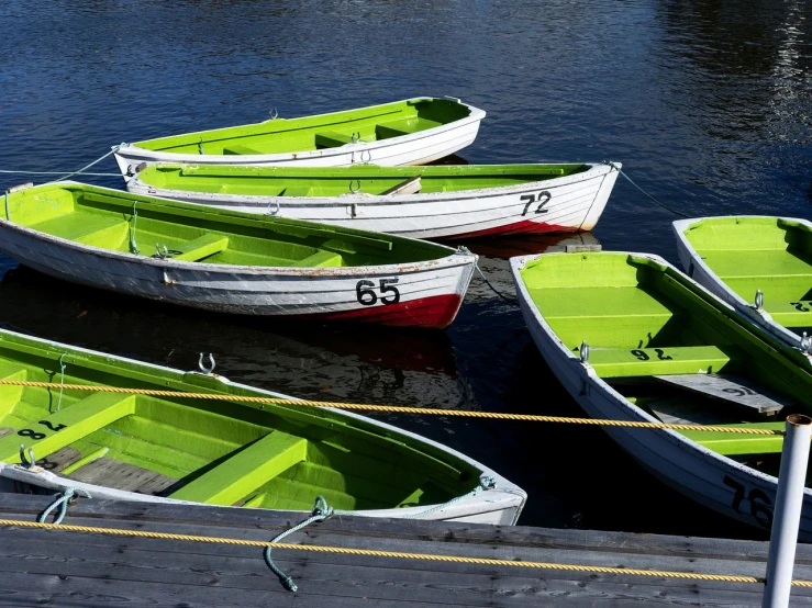 a group of green and white boats tied to a dock, a picture, by Jens Jørgen Thorsen, 4k photo”, colourful, variation, information