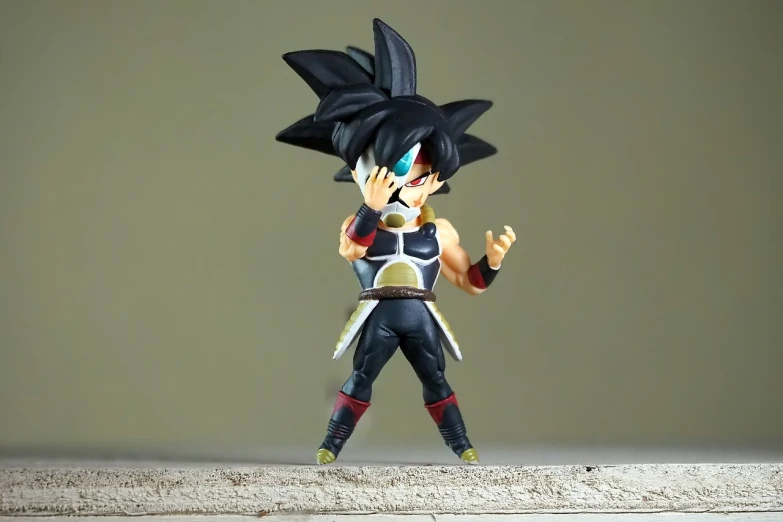 a close up of a toy figure on a table, a picture, inspired by Toriyama Sekien, unsplash, vanitas, an anime nendoroid of son goku, sharp sleek edged black armor, dynamic pose full body, dark visor covering eyes