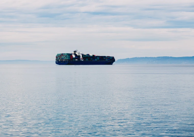 a large boat in the middle of a large body of water, a portrait, by Alexander Bogen, pexels, container ship, seattle, iso 1 0 0 wide view, benjamin vnuk