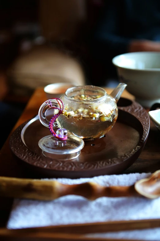 a close up of a plate of food on a table, a tilt shift photo, by Li Mei-shu, renaissance, teapot, relaxing atmosphere, inside a glass jar, highly detailed product photo