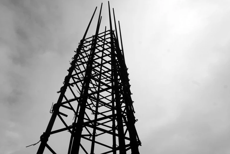 a black and white photo of a tall tower, by Robin Guthrie, flickr, new sculpture, silhouette, construction, rack, cellular