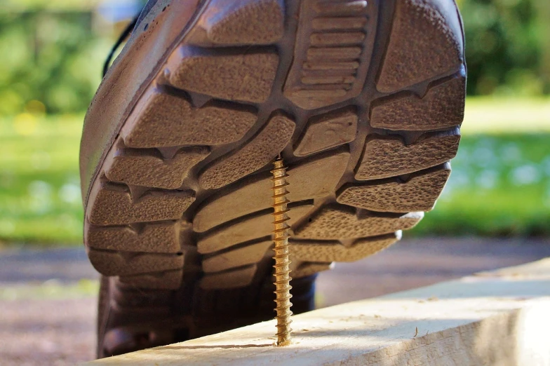 a close up of the sole of a pair of shoes, by Jan Rustem, exposing screw, lumberjack, construction, motivational