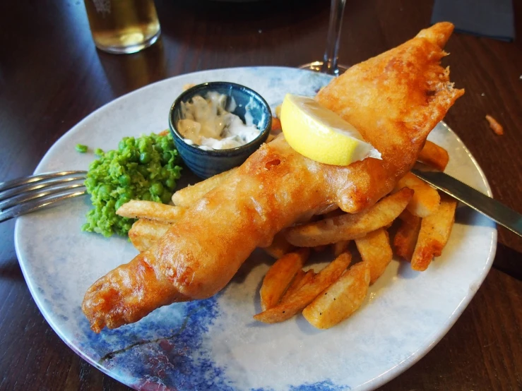 a close up of a plate of food on a table, by Joe Bowler, in the pub, style of chippy, shark, food blog photo