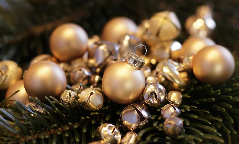 a close up of a bunch of ornaments on a tree, pixabay, realistic gold, still life, bells, tan