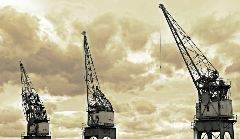 a group of cranes sitting on top of a body of water, a photo, flickr, constructivism, port scene background, dramatic skies, banner, high details!