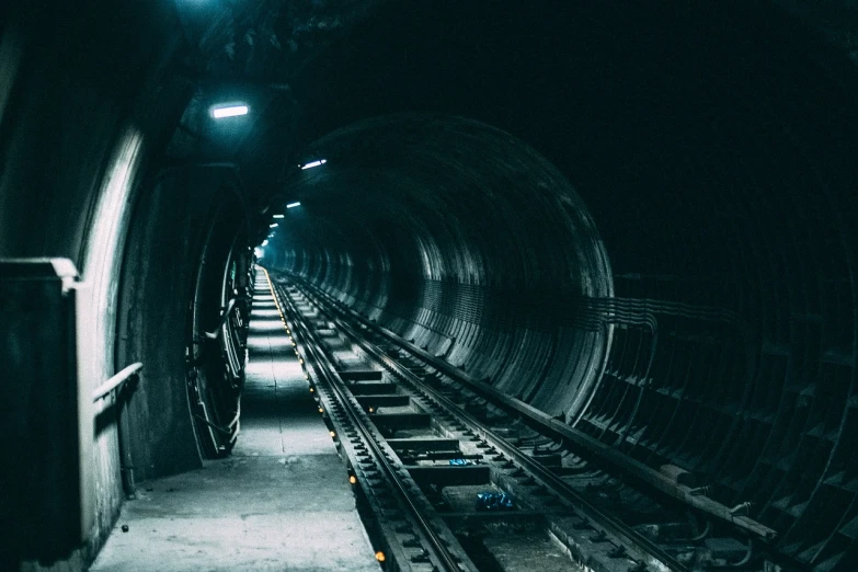 a train that is going through a tunnel, by Adam Szentpétery, unsplash contest winner, dark industrial background, down in the sewers of london, industrial futuristic ice mine, terminals