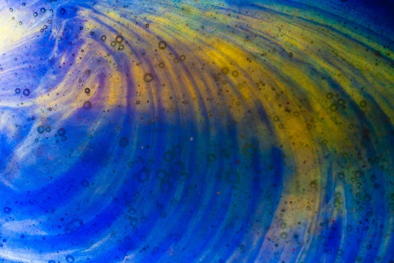 a close up of a blue and yellow painting, a microscopic photo, by Jan Rustem, flickr, iridescent venetian blown glass, particle waves, stained glass background, universe in a grain of sand