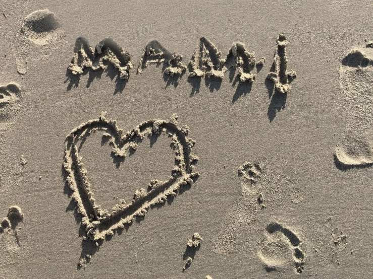 a heart drawn in the sand on a beach, by Edna Mann, graffiti, calligraphy, happy feeling, magali, mom