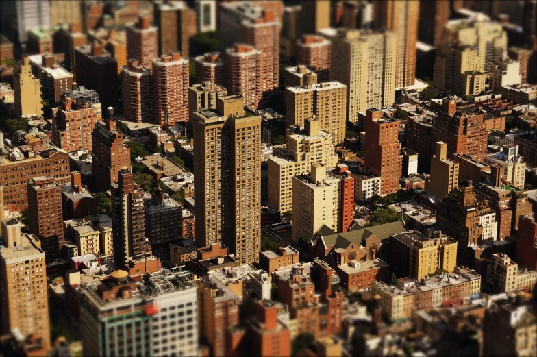 a city filled with lots of tall buildings, a tilt shift photo, by Andrew Domachowski, flickr, harlem, slice of life”