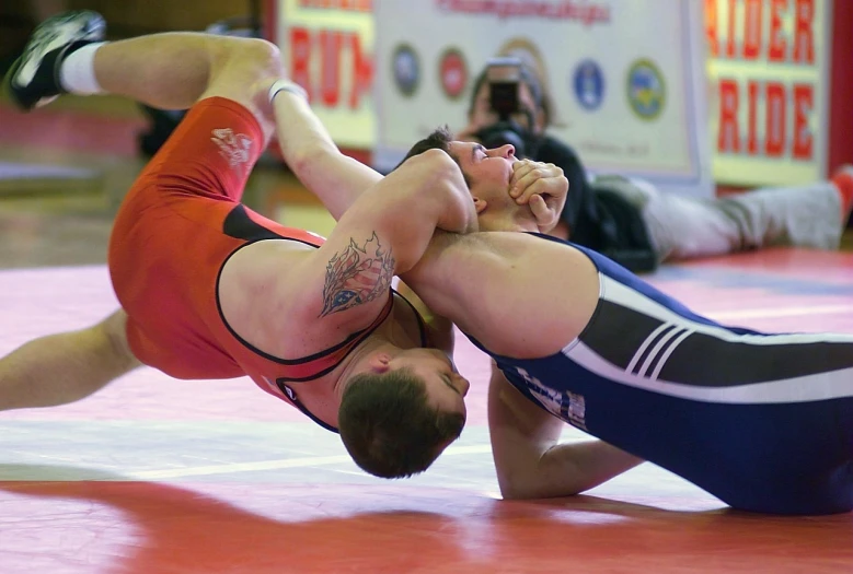 a man wrestling another man in a wrestling match, by Tom Carapic, modern very sharp photo, dsrl photo, wikimedia commons, jakub rebelka