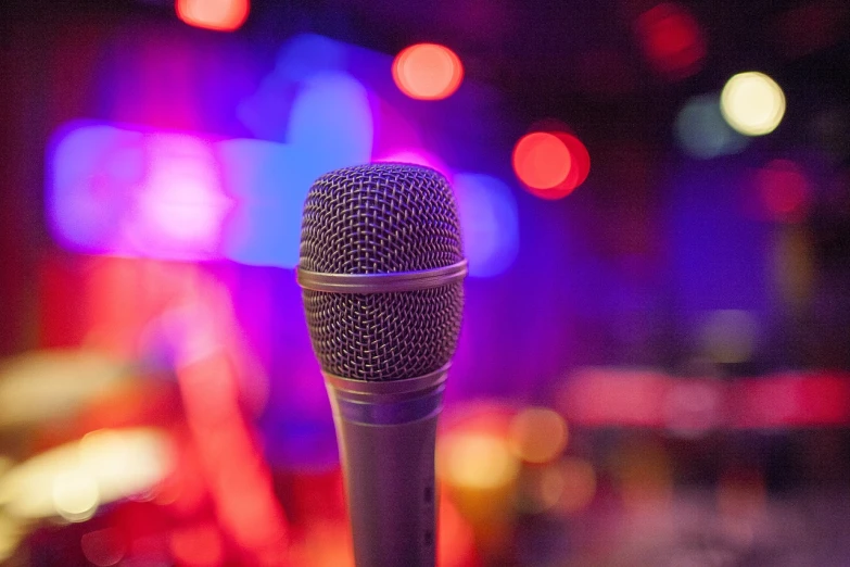 a microphone sitting on top of a table, a picture, shutterstock, happening, night life, slightly colorful, tall thin, tony roberts