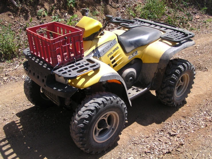 a yellow four wheeler parked on a dirt road, flickr, dau-al-set, shopping cart, heavily equipped, controller, not cropped