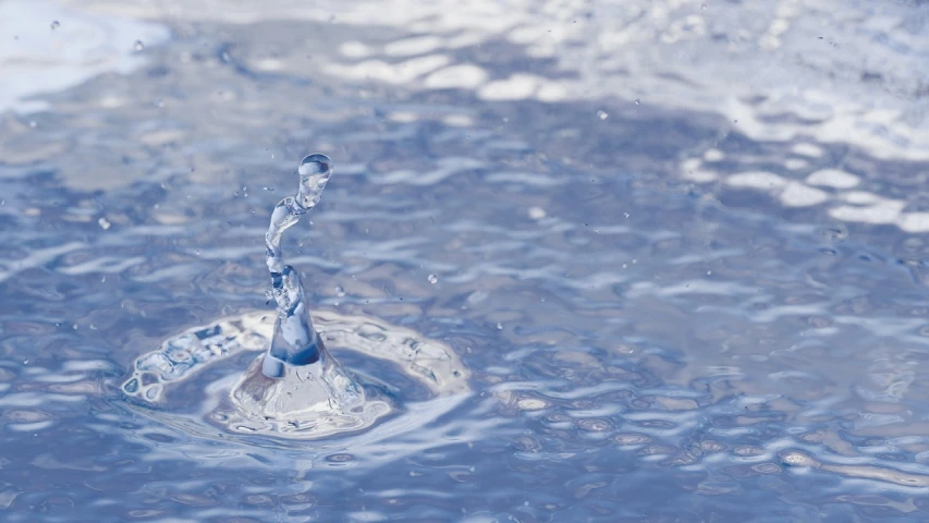 a water drop falling into a pool of water, a digital rendering, shutterstock, water pipe, medium close-up shot, on a sunny day, miniature product photo