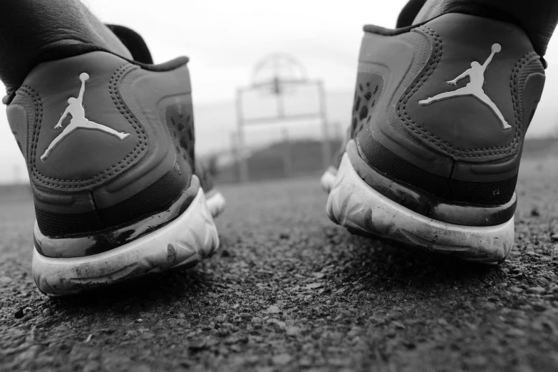 a black and white photo of a pair of sneakers, by Matija Jama, on a racetrack, :: morning, bumps, dof