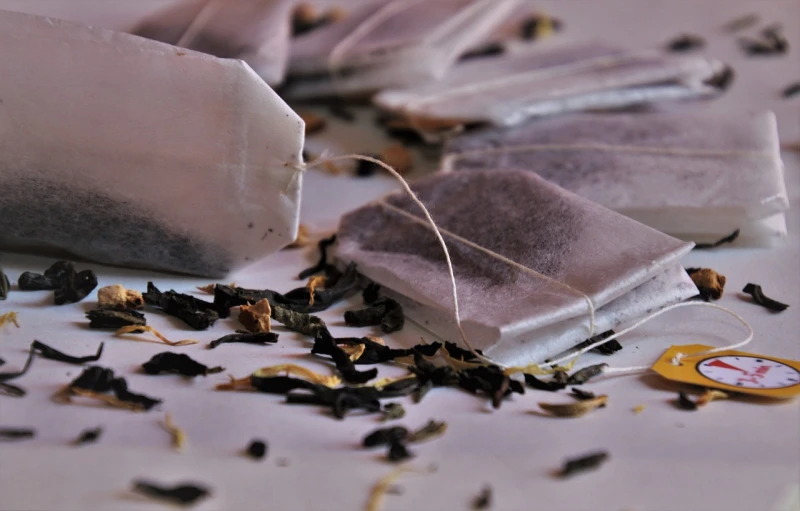 a pile of tea bags sitting on top of a table, a picture, by Magdalene Bärens, unsplash, ivory and black marble, salvia, rice paper texture, exquisite detail