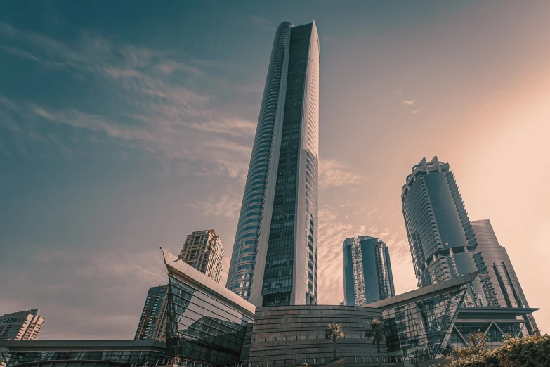 a tall building sitting in the middle of a city, shutterstock, cinematic style photograph, dubai, highly detail wide angle photo, in neotokyo