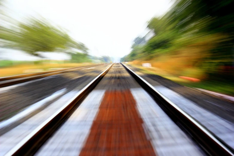 a blurry photo of a train track, by David Burton-Richardson, istockphoto, jumping towards viewer, first-person pov, photo-shopped